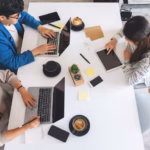 top-view-image-people-using-working-laptop-computer-tablet-pc-table-office_9563-10141